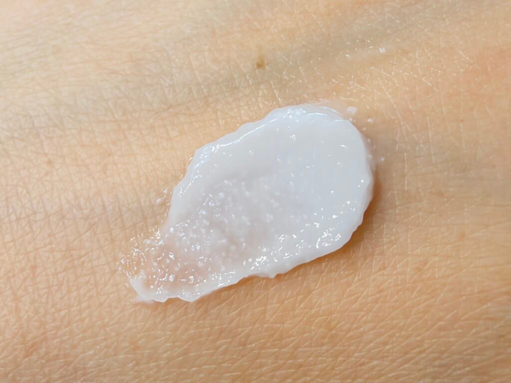 Close-up swatch of Aestura Atobarrier 365 Cream on hand showing visible white DermaON ceramide micro-capsules.
