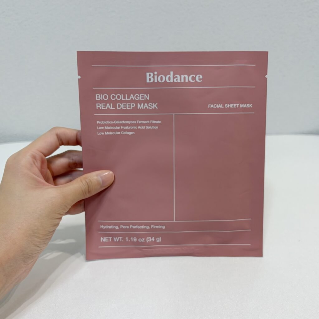 Hands holding the pink packaging of Biodance Bio-Collagen Real Deep Mask, one of the viral K-beauty products tested in Seoul.