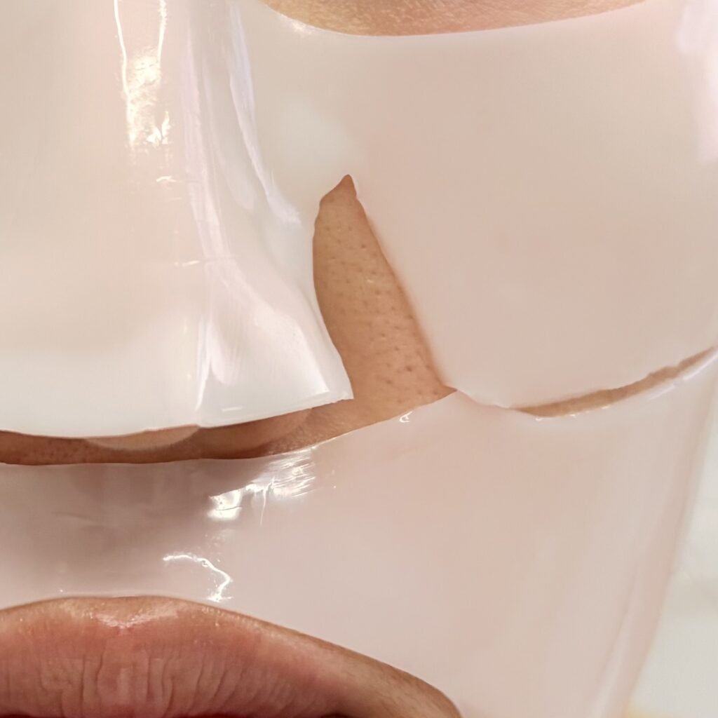 Close-up shot of the Biodance Bio-Collagen Real Deep Mask adhering tightly to the butterfly zone, nose, and philtrum.