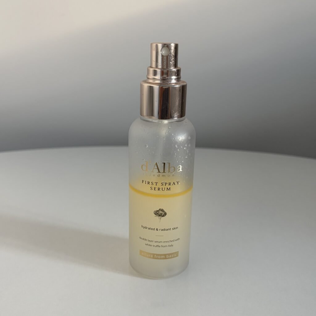 d'Alba White Truffle First Spray Serum showing the distinct golden plant-oil layer resting atop the hydrating serum base.